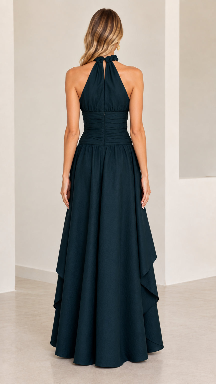 Back view of model in dark green halter evening gown showing high back closure