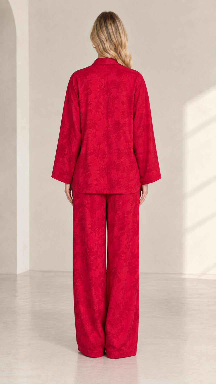 Back view of women's red jacquard long sleeve top and matching trousers