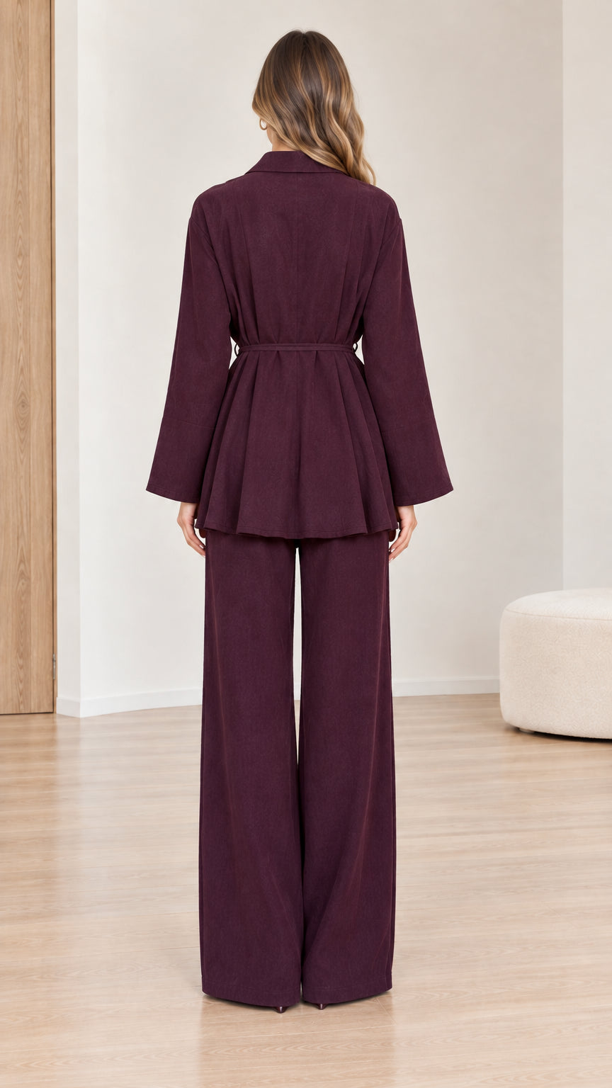 Back view of woman wearing burgundy long-sleeve peplum set