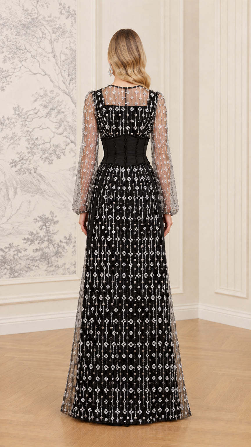 Back view of black long sleeve formal gown with sheer back yoke and full-length skirt