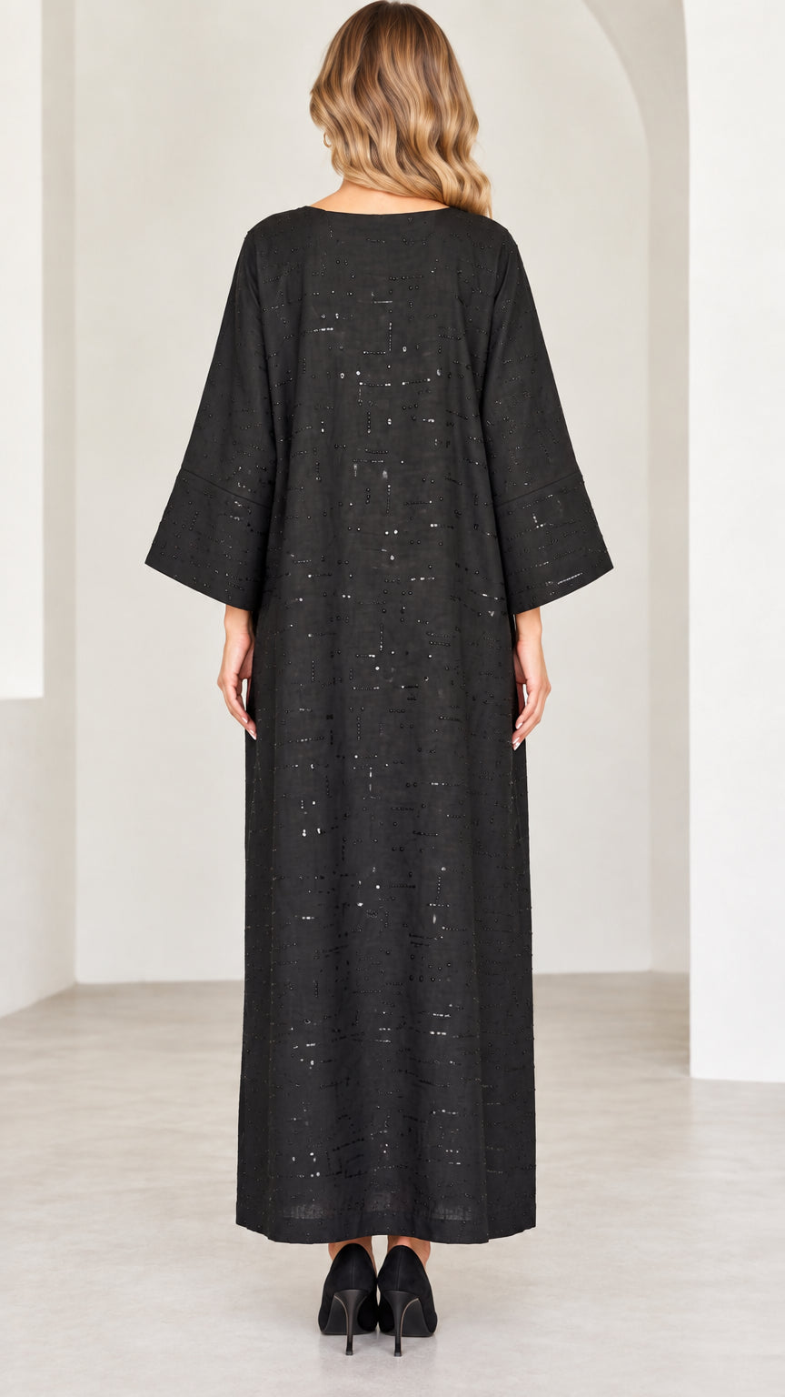 Back view of model wearing black long sleeve sequined maxi dress
