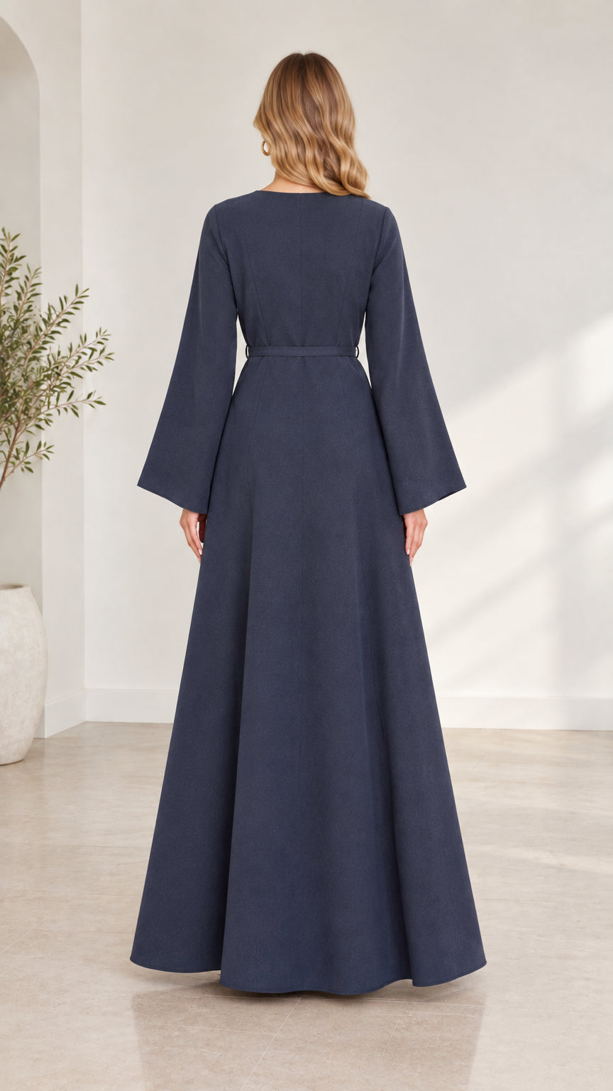 Back view of woman wearing navy blue long-sleeve maxi dress showing clean silhouette