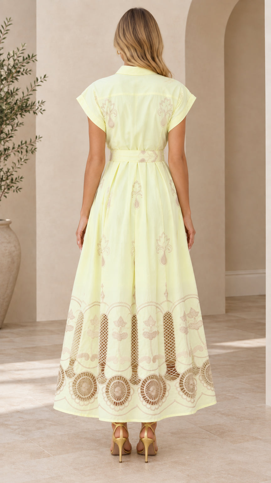 Back view of pale yellow collared maxi dress featuring waist belt and flared skirt