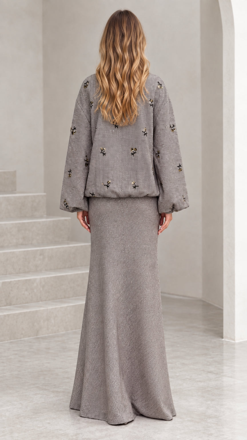 Back view of woman wearing grey embellished tweed two-piece skirt set