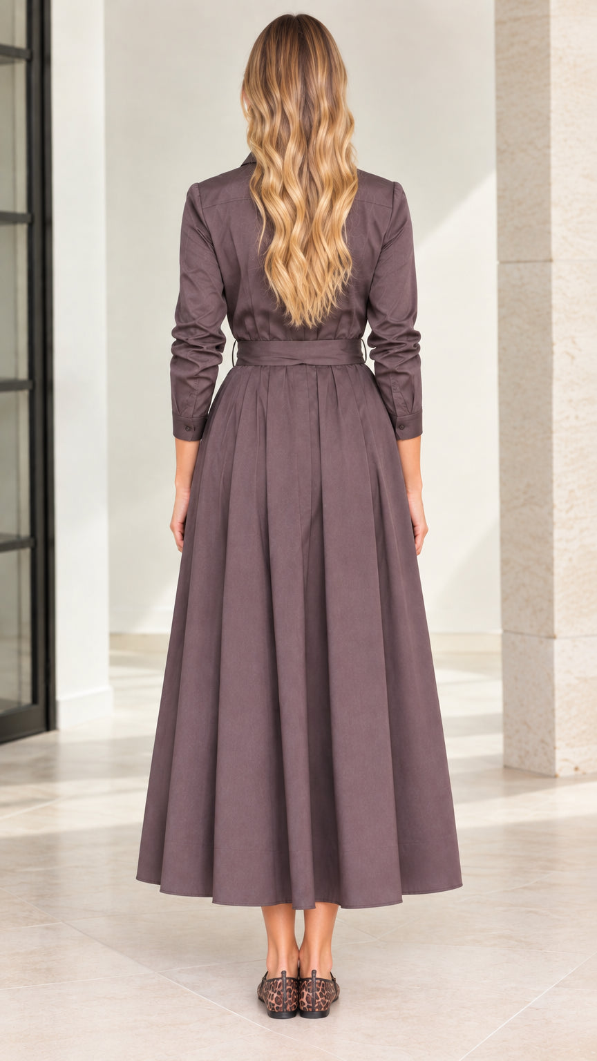 Back view of model wearing mocha brown belted pleated midi shirt dress