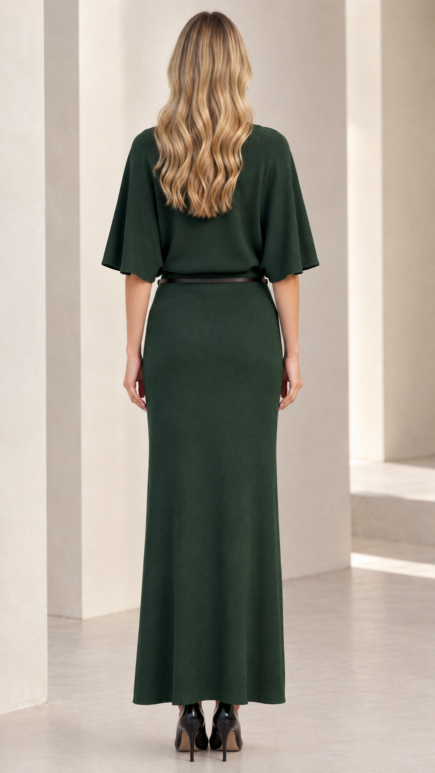Back view of woman wearing dark green flutter sleeve knit maxi dress