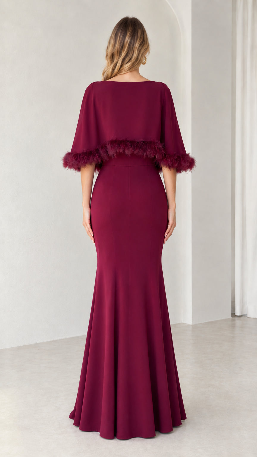Back view of floor-length burgundy formal dress with cape overlay