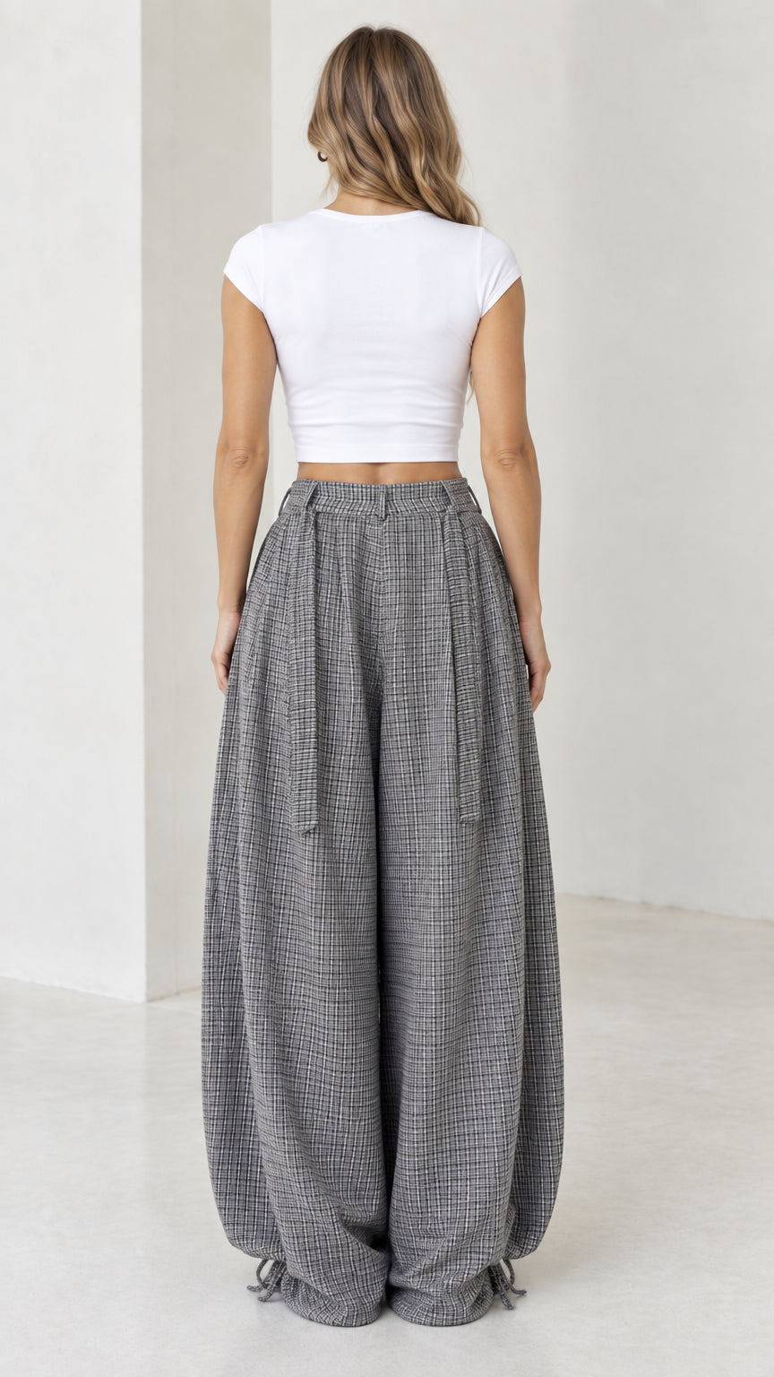 Back view of woman wearing grey micro-plaid wide leg balloon pants