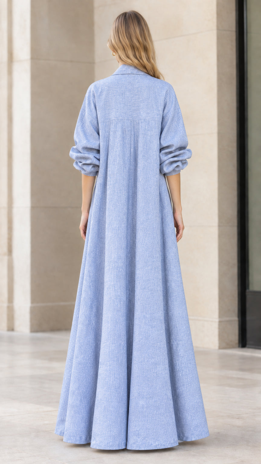 Back view of light blue maxi duster coat showing gathered back yoke