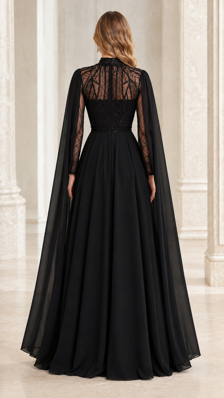 Back view of black evening gown highlighting sheer beaded illusion back and cape drape