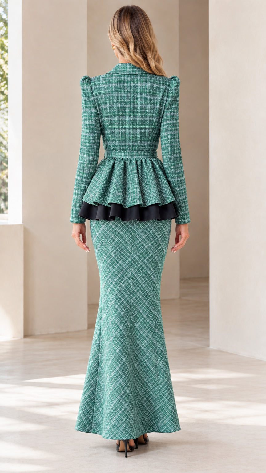 Back view of woman wearing the green tweed peplum jacket and fluted maxi skirt