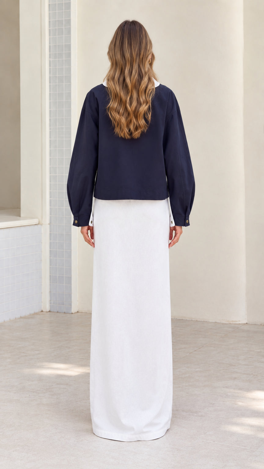 Back view of the navy women's utility jacket with cropped upper-hip length