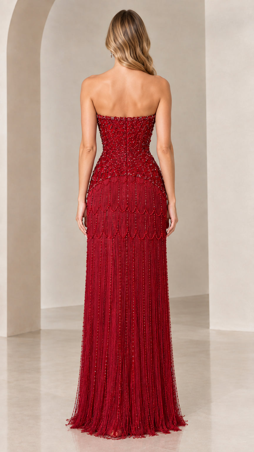 Back view of model in burgundy strapless evening gown showing fit