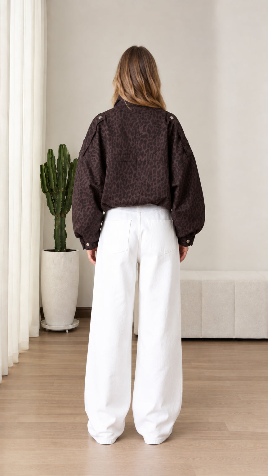 Back view of model wearing chocolate brown animal print pullover jacket