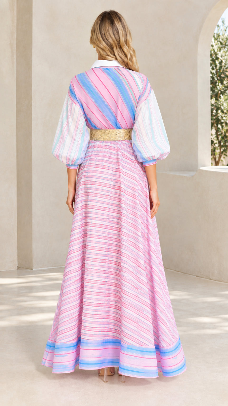 Back view of woman wearing pink multi striped lantern sleeve maxi dress