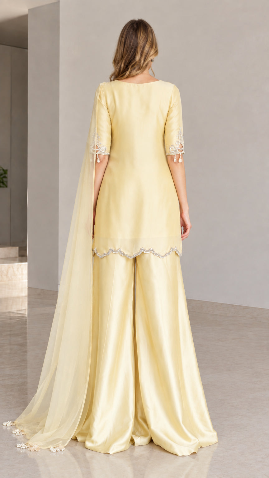 Back view of lemon yellow kurta sharara ensemble showing elegant drape
