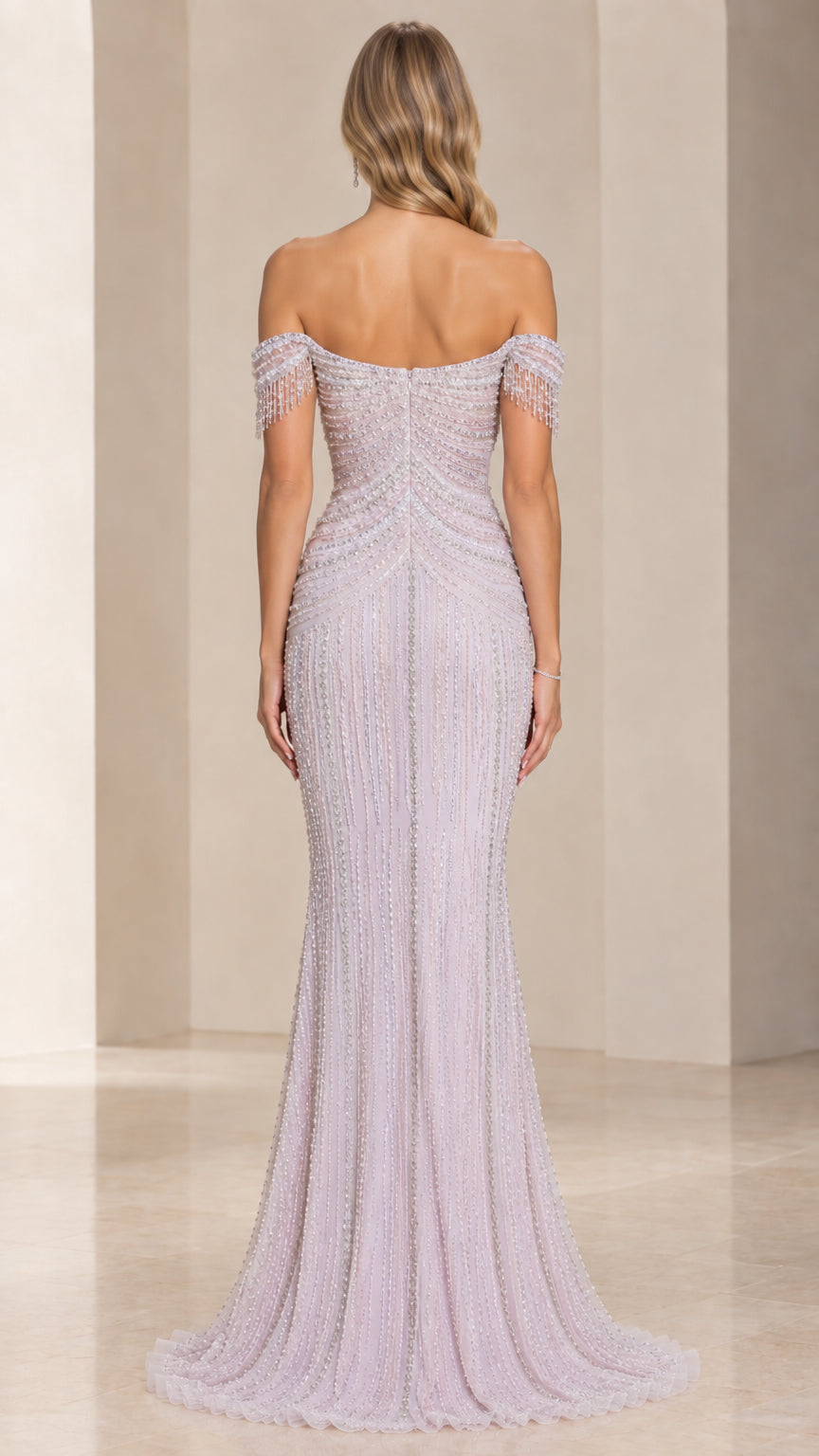 Back view of model in off-the-shoulder beaded evening dress with delicate train