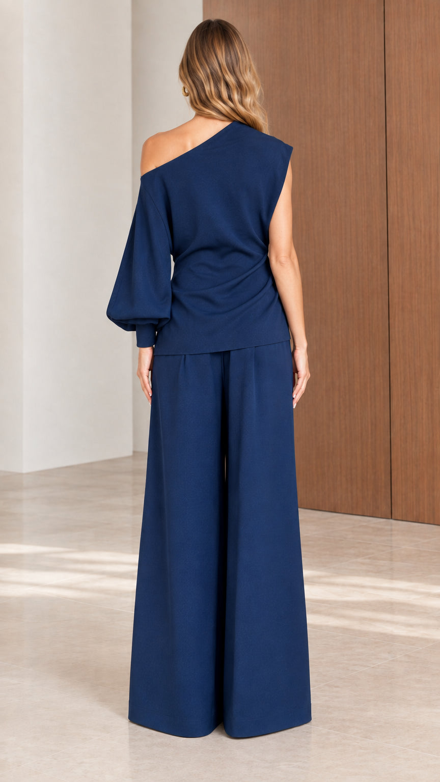 Back view of model wearing Navy Blue two-piece one-shoulder pant set