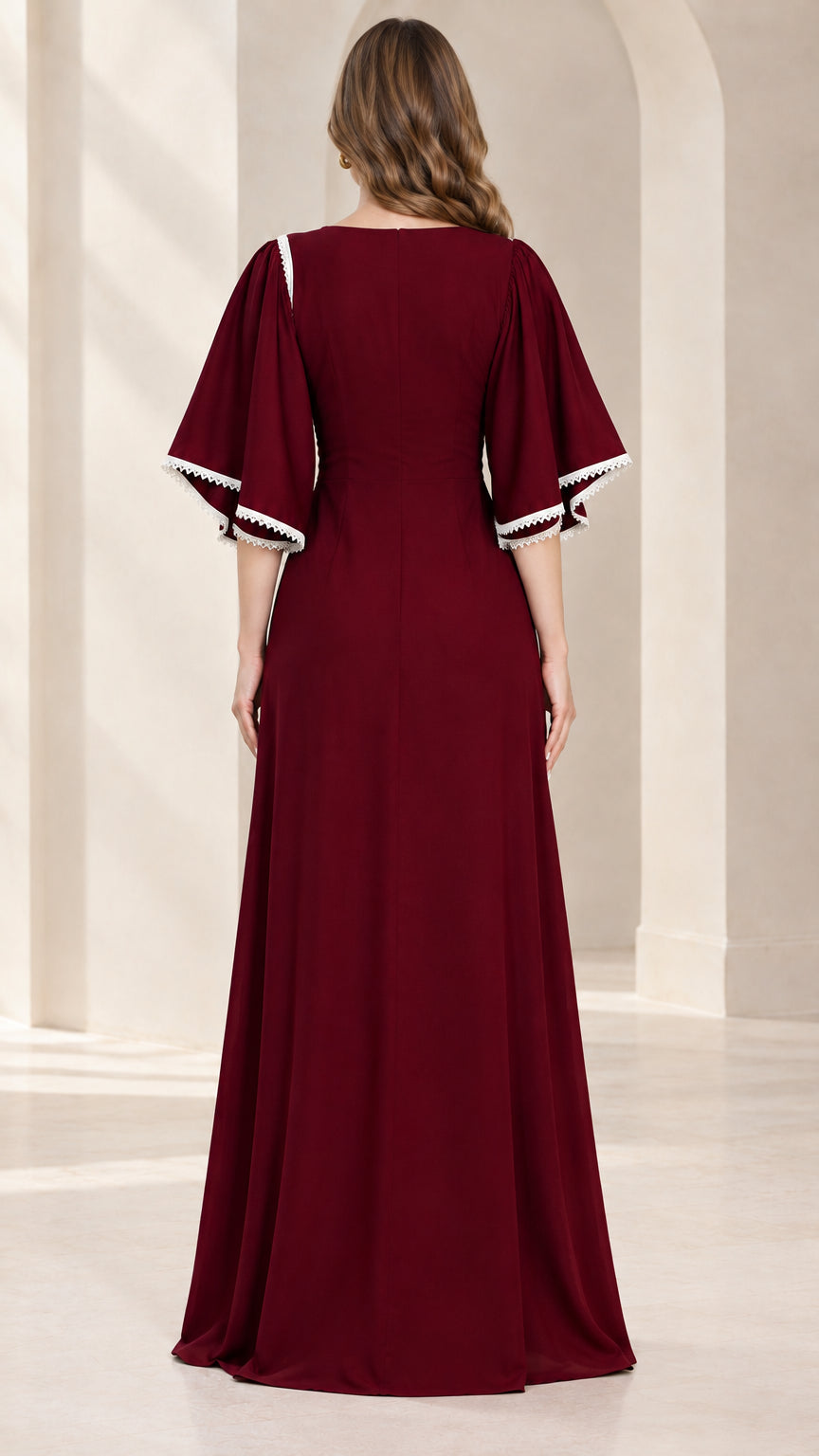 Back view of model wearing full-length burgundy formal dress