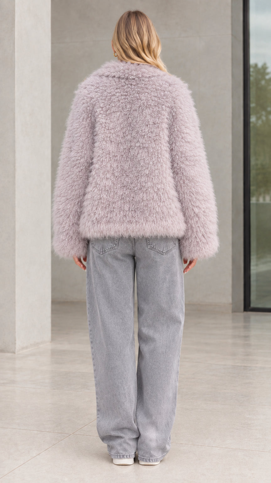 Back view of model wearing dusty lilac curly faux fur jacket