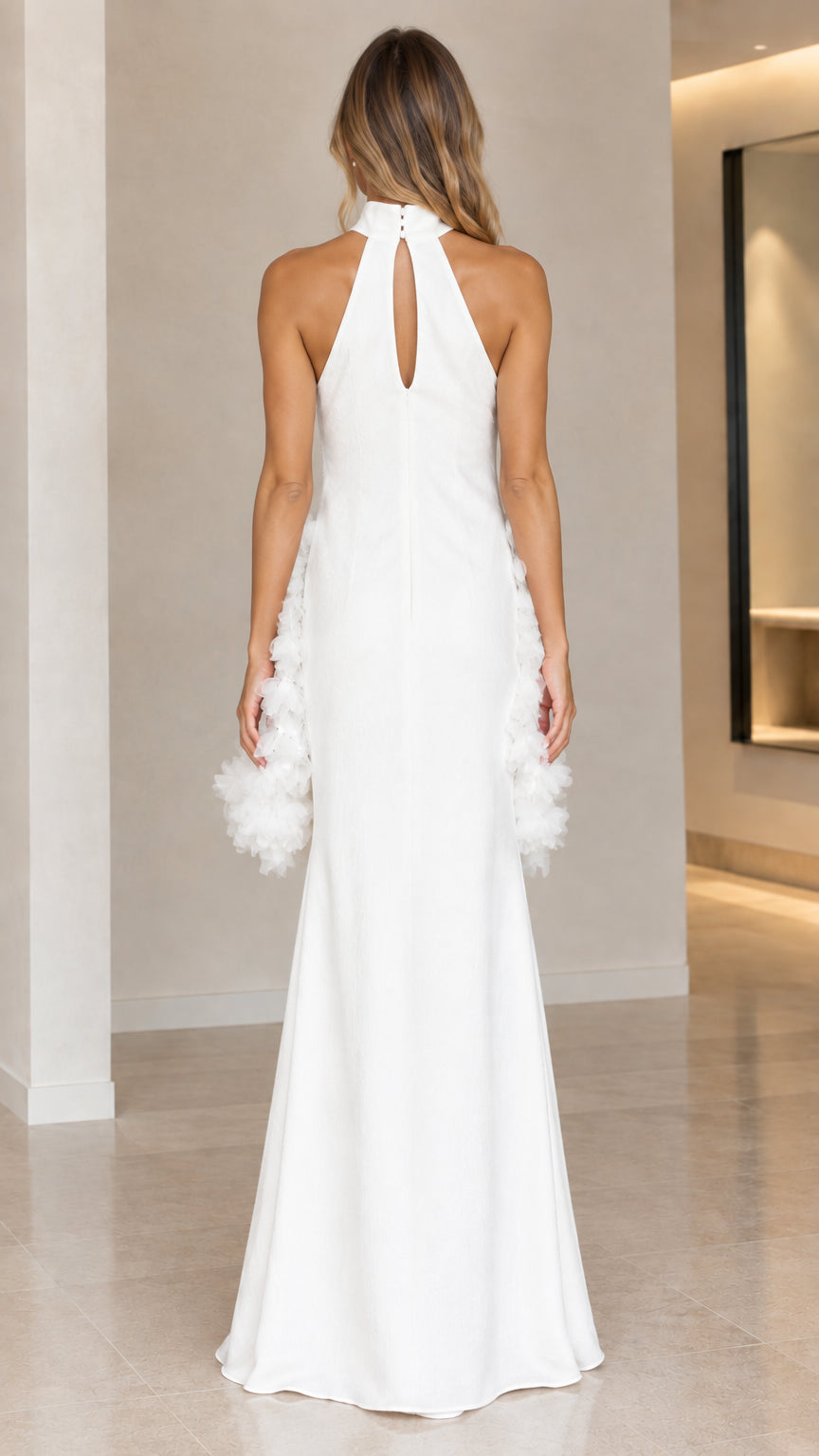 Back view of white halter evening dress showing keyhole opening and button closure