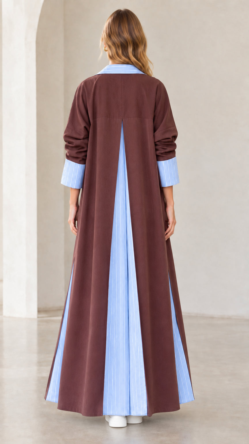 Back view of women's brown longline coat showcasing deep inverted striped back pleat