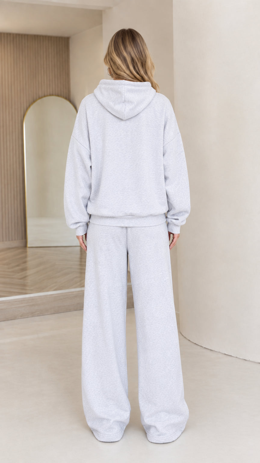 Back full-body view of model in light grey wide leg tracksuit set