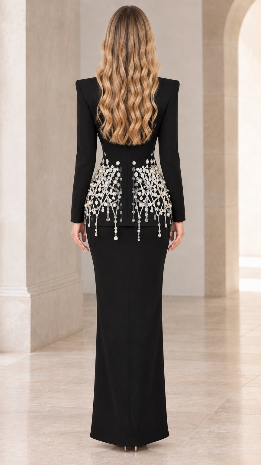 Back view of model showing tailored fit and embellishments of black skirt suit set