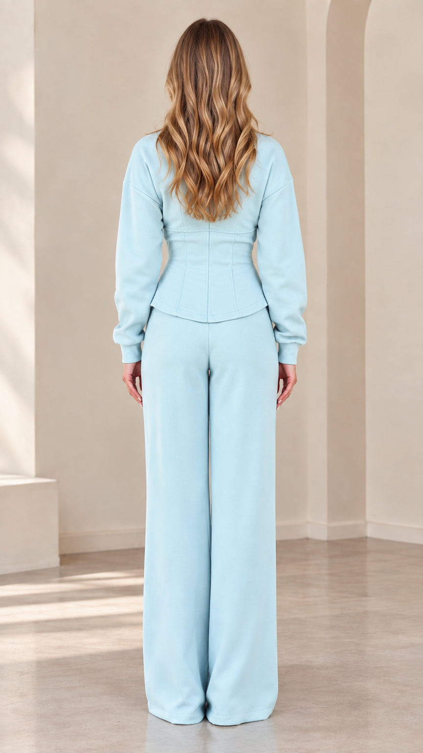 Back view of model in Light Blue corset-seamed jacket and wide-leg pants
