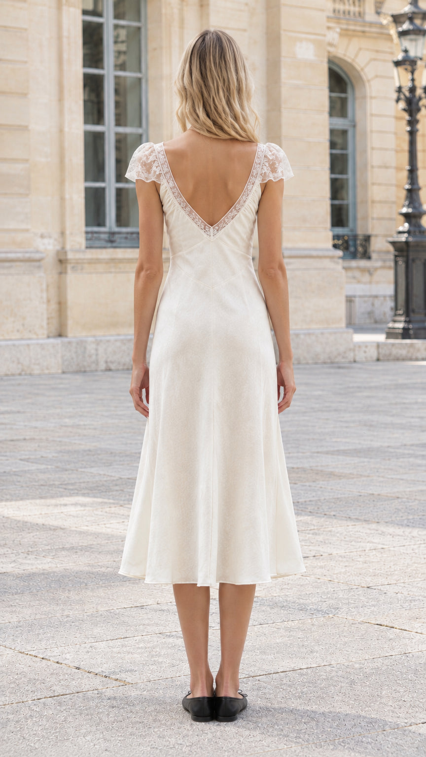 Back view of ivory satin dress showing deep V-back with lace trim