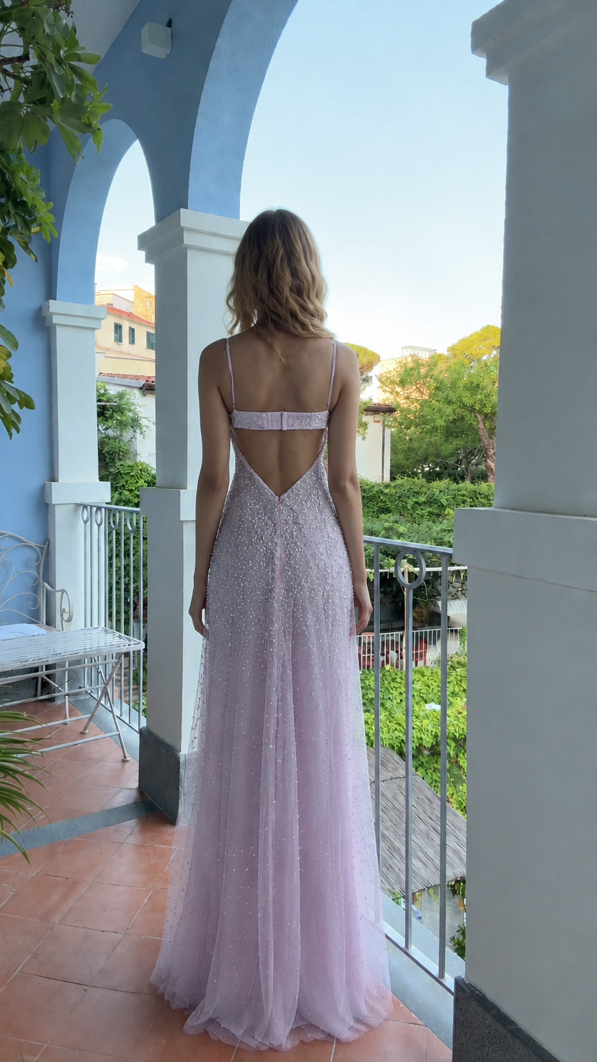 Back view of woman wearing lavender open-back beaded evening dress