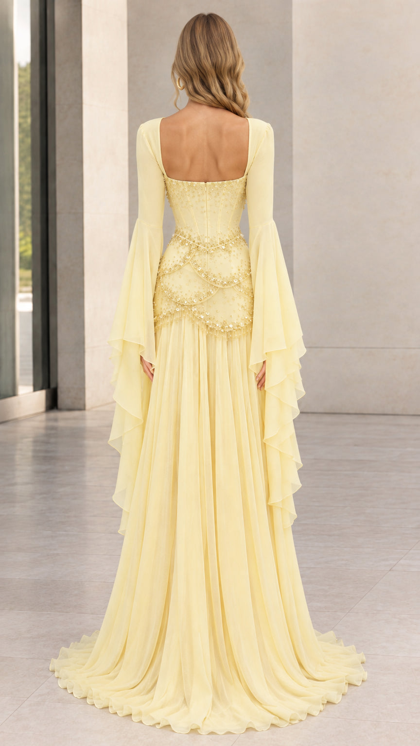 Back view of pastel yellow corset evening gown showing open square back and flowing skirt