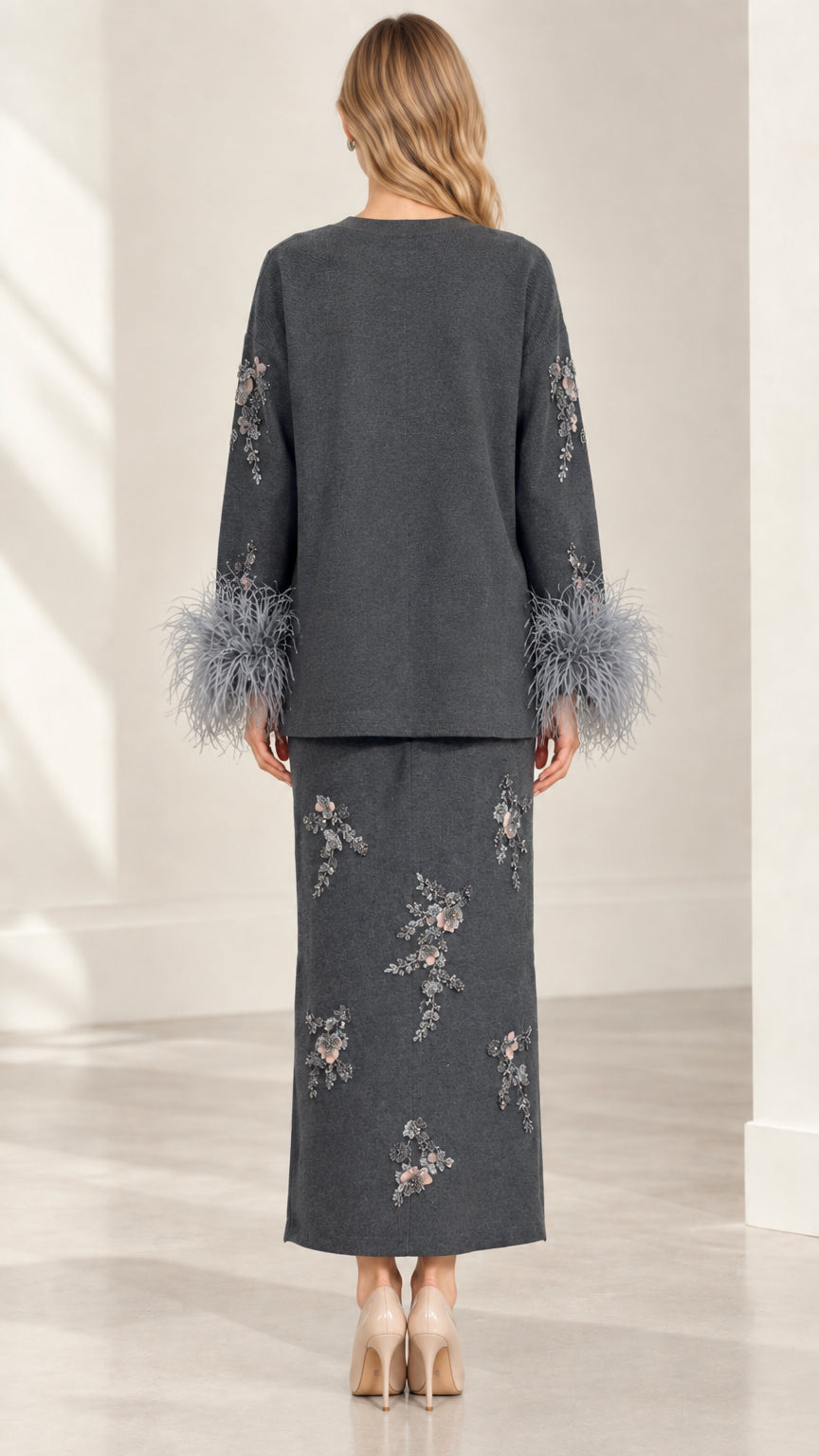 Back view of model wearing Charcoal Grey two-piece knit cardigan and maxi skirt set