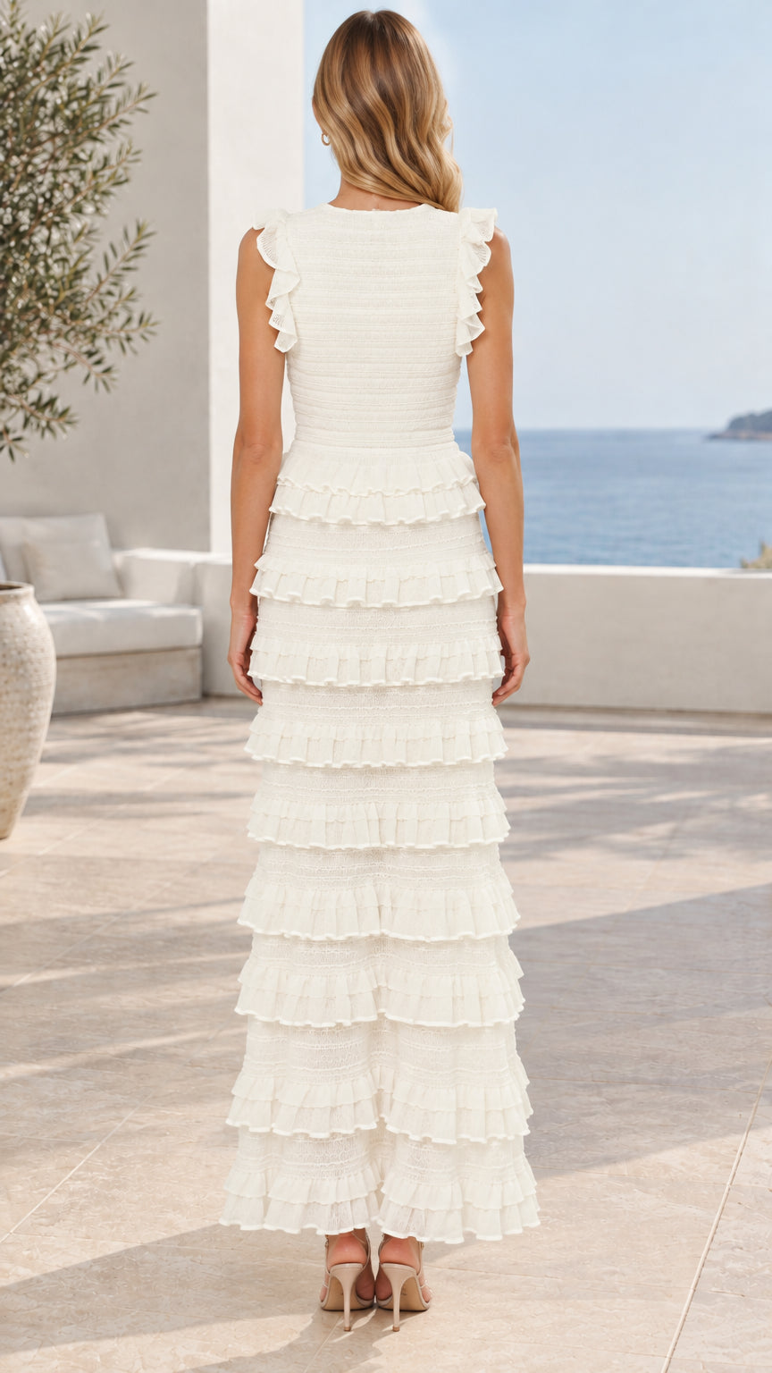 Back view of model wearing white sleeveless tiered ruffle maxi dress