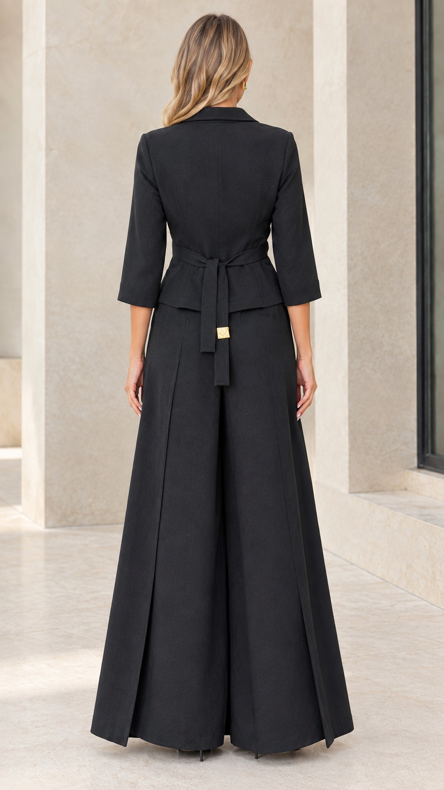 Back view of black pantsuit showing back waist tie belt and pleated trousers