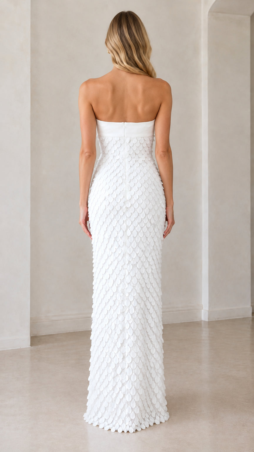 Back view of model wearing white strapless column maxi dress