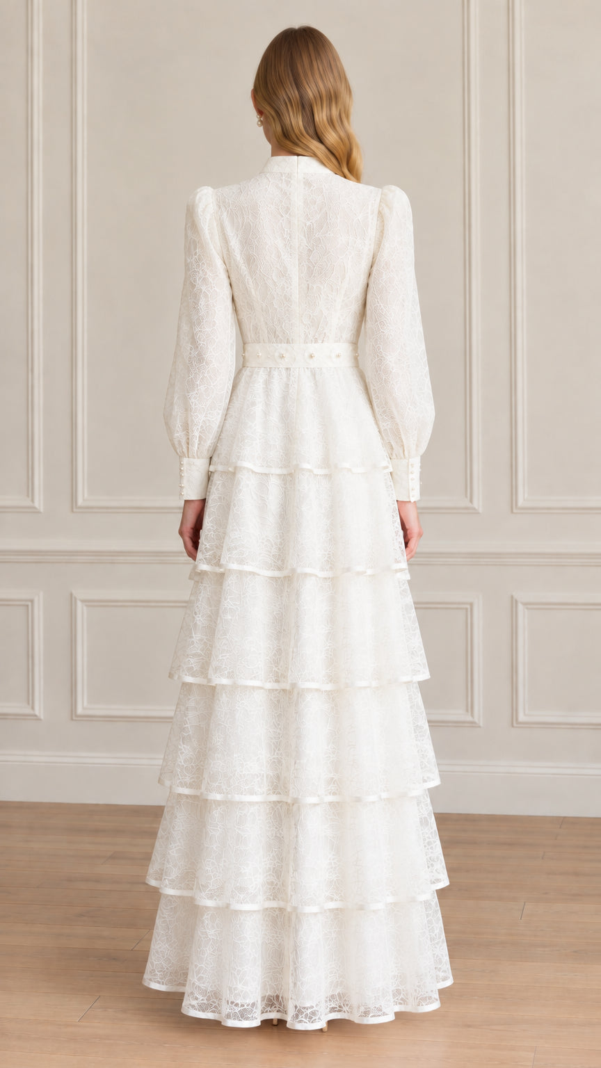 Back view of model showing full length white tiered lace dress with high collar