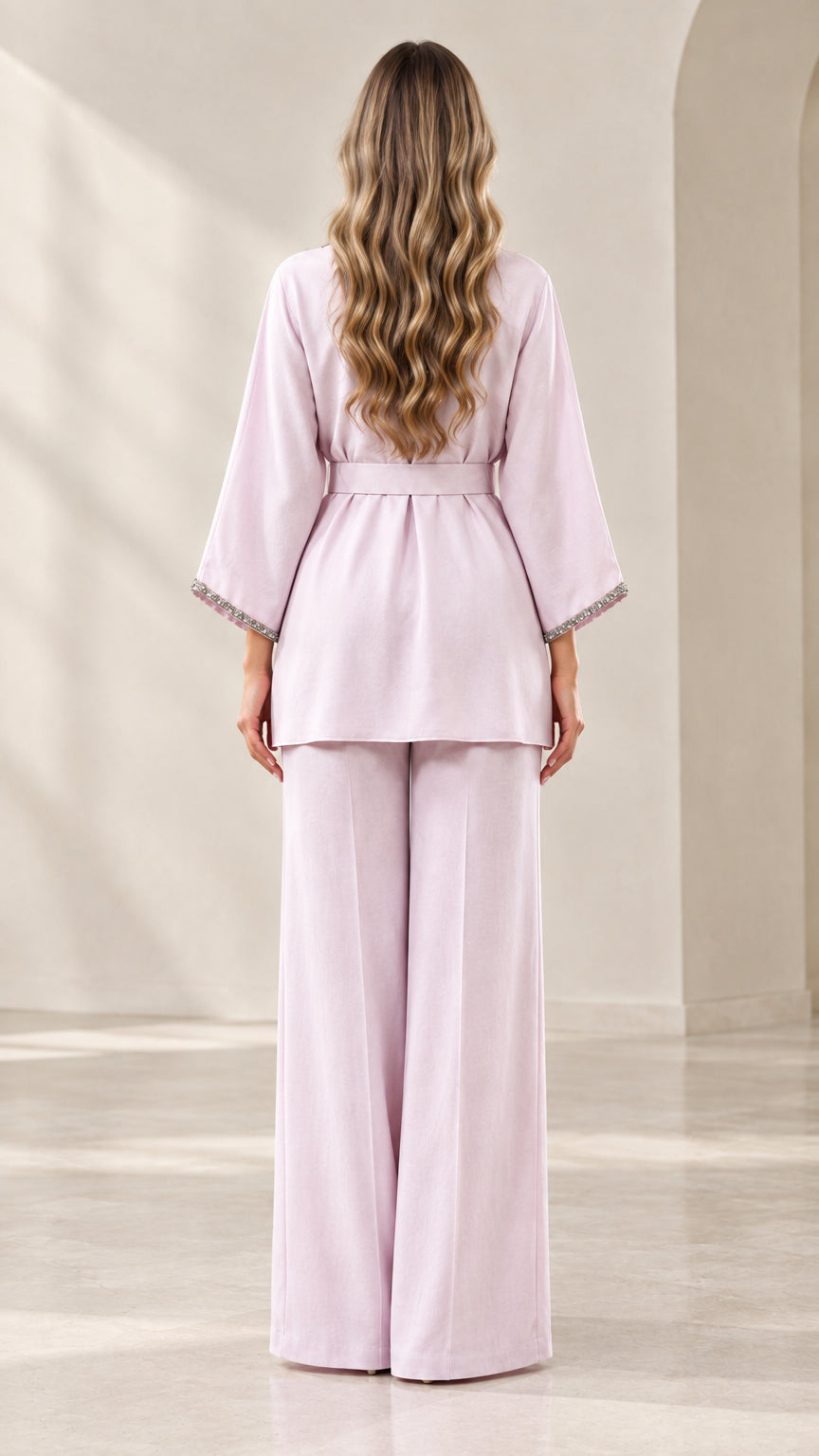 Back full-length view of model wearing the lilac belted tunic and wide-leg matching pants