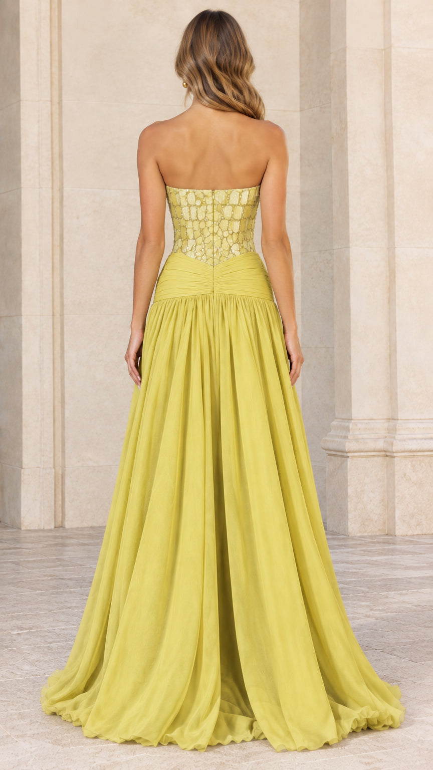 Back view of model in chartreuse strapless maxi gown