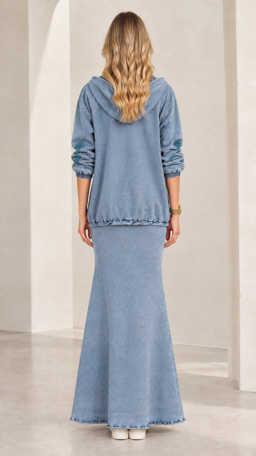 Back view of model wearing Light Blue hooded jacket and long denim skirt