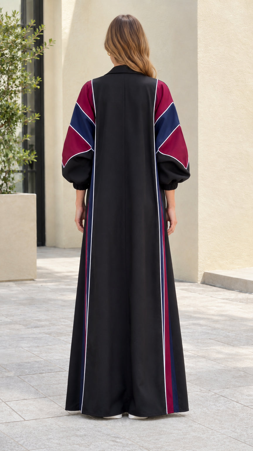 Back view of model wearing black colorblock open duster coat and palazzo pants