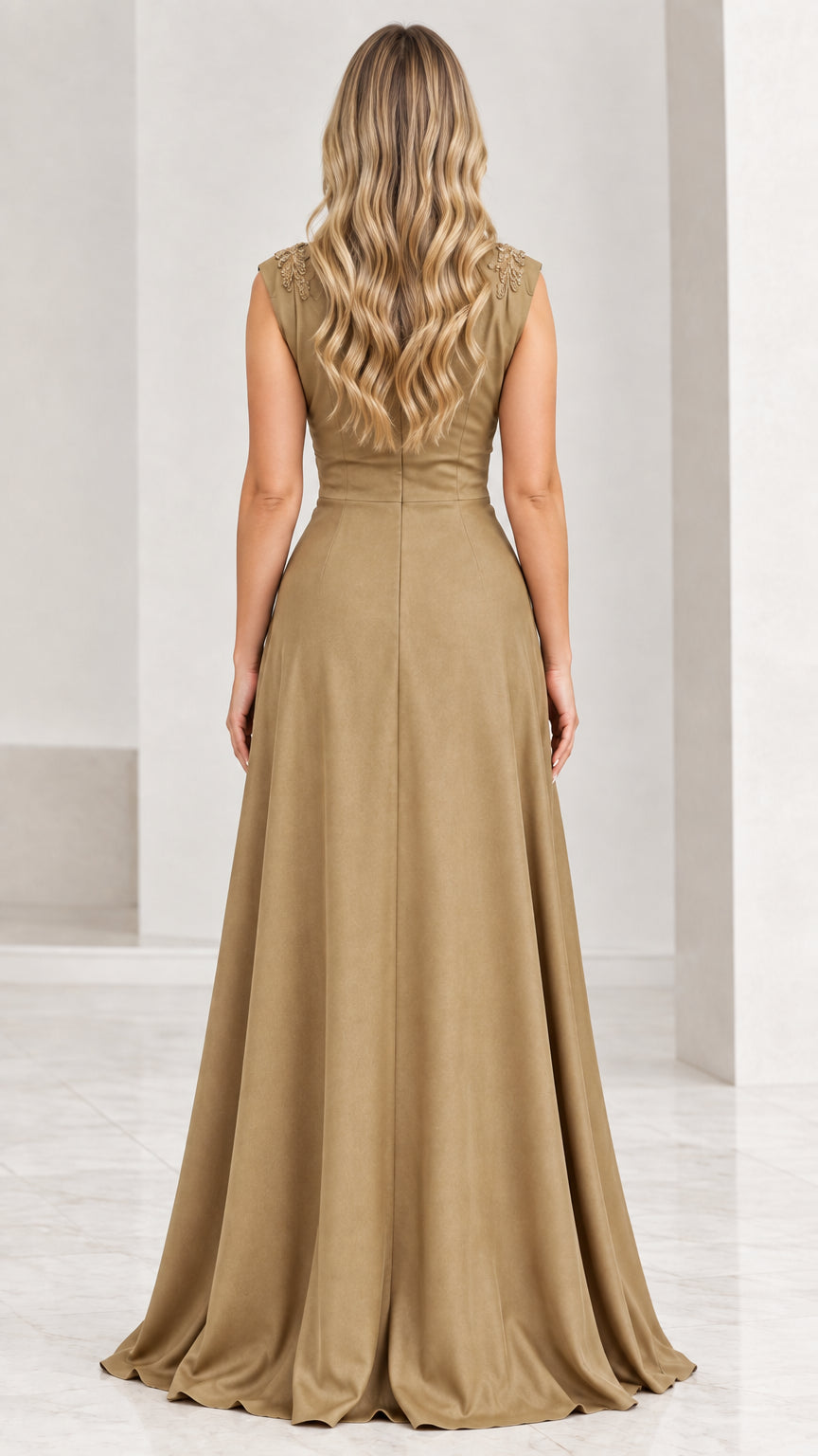 Back view of gold evening gown showing clean V-back and fluid pleated skirt