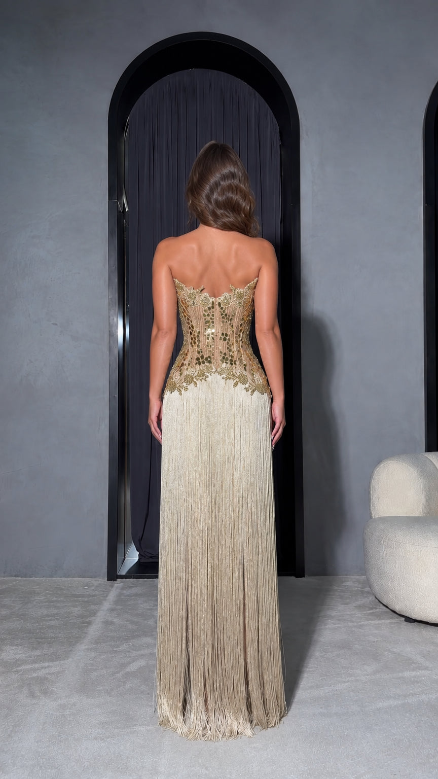 Back view of Champagne Gold strapless corset fringe maxi dress