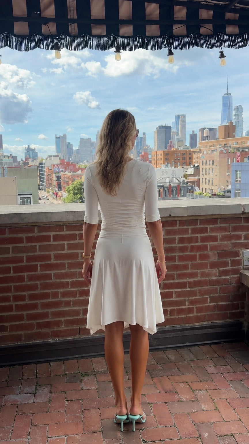 Back view of cream half-sleeve ribbed top and matching flowy skirt