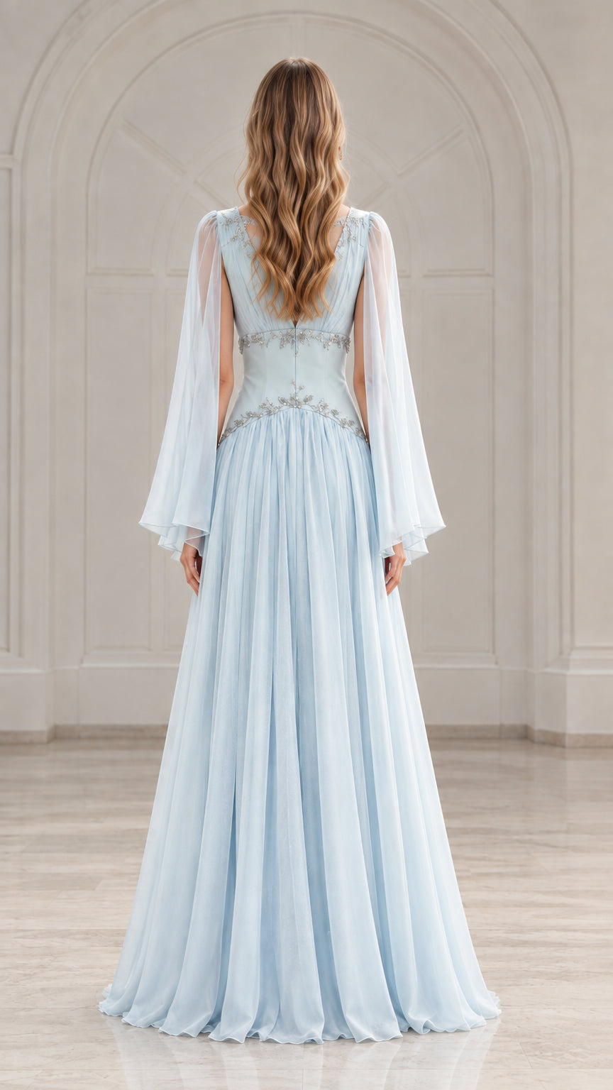 Back view of model in a sky blue formal chiffon maxi dress showing cape sleeve drape