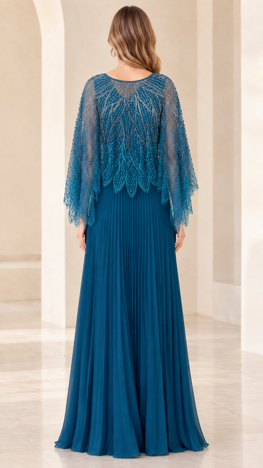 Back view of teal blue pleated maxi evening dress with beaded cape overlay