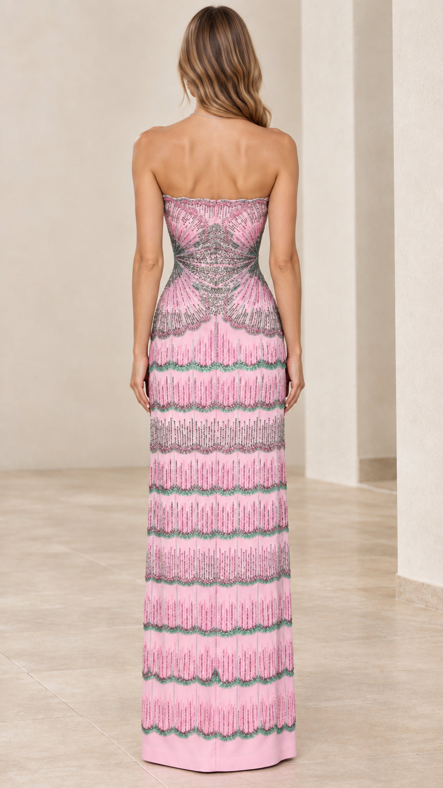Back view of woman wearing pink strapless beaded formal gown