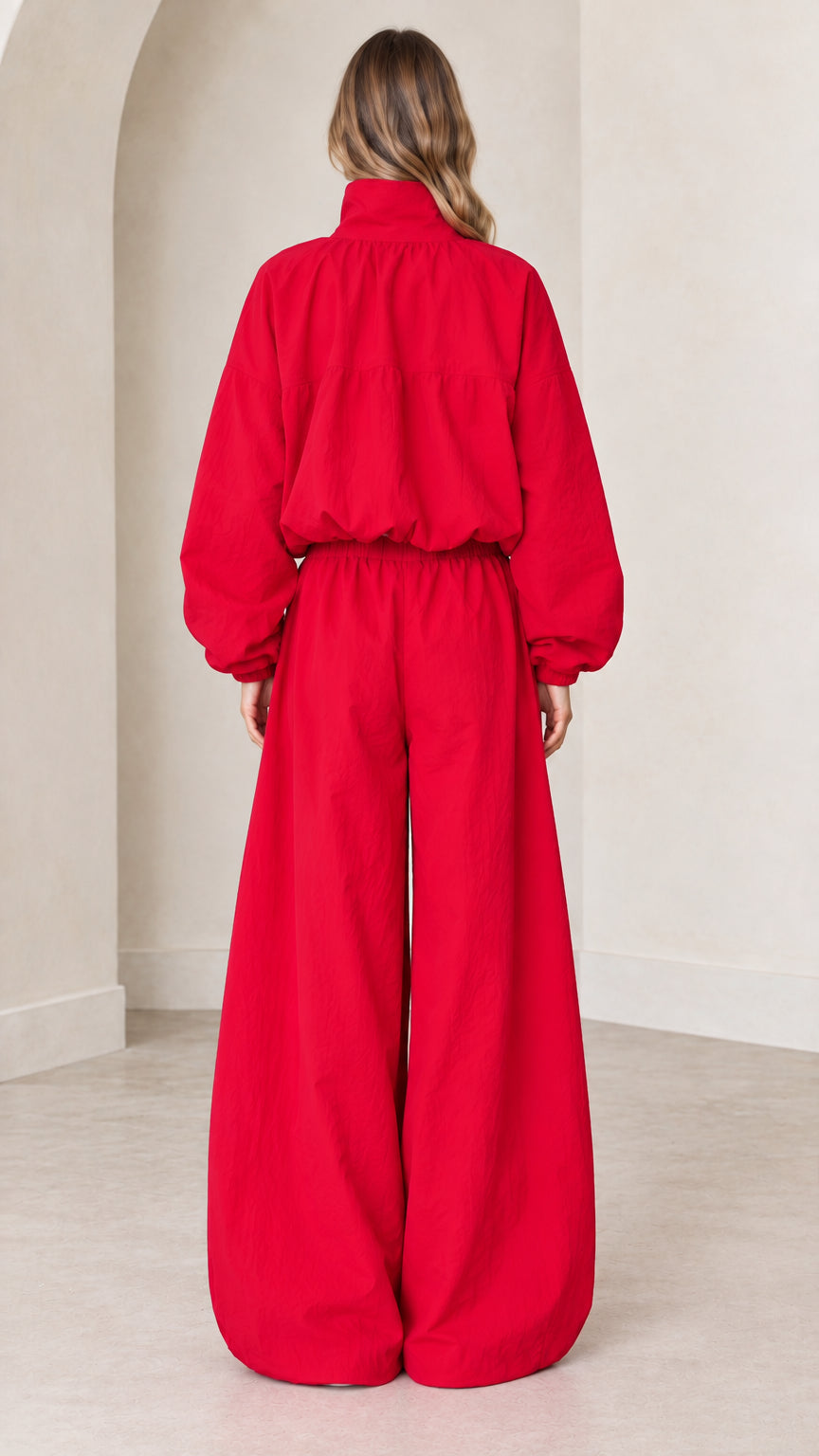 Back view of woman wearing oversized red balloon leg tracksuit jumpsuit