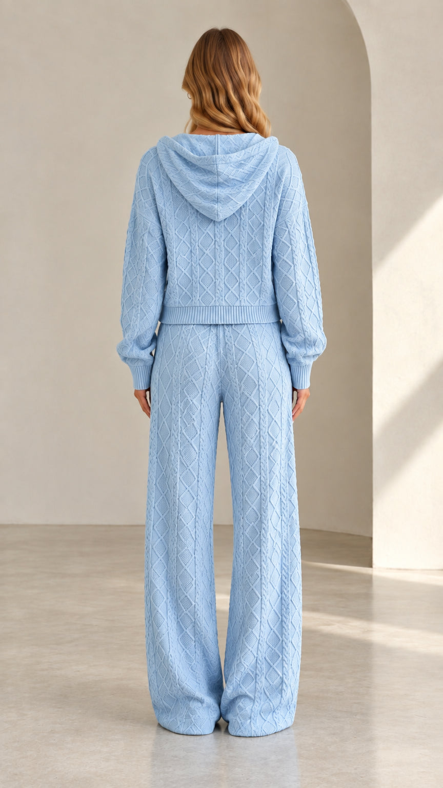 Back view of light blue cable knit hooded sweater and wide leg pants set