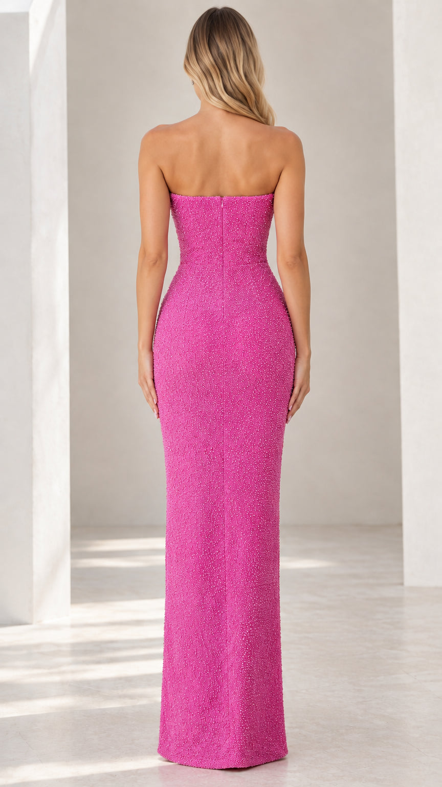 Back view of fuchsia strapless column evening dress showing zip closure